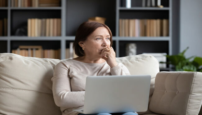 woman pondering on computer